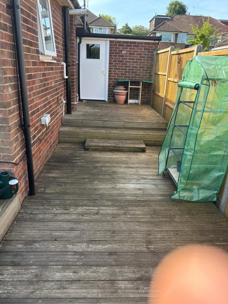 Old timber decking area before garden renovation
