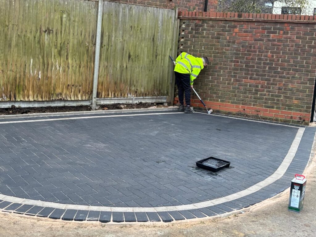 Resin-bound driveway being installed with brick border – Essex surface solutions