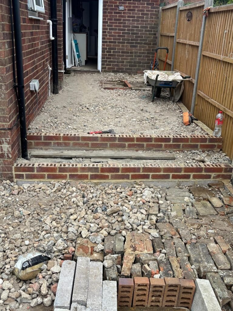 Garden steps under construction using reclaimed brick and hardcore base – back garden renovation