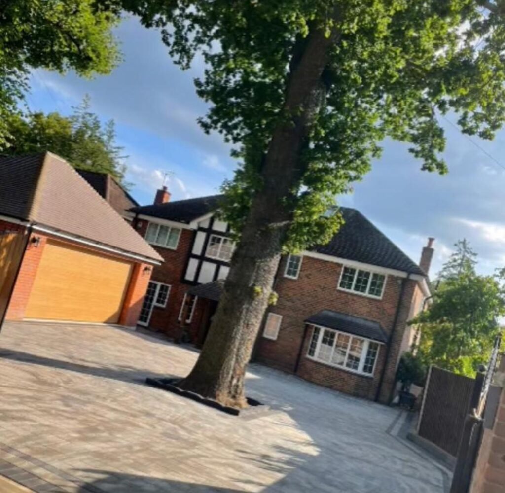 Large driveway with charcoal block paving around mature tree – bespoke paving Essex